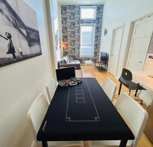 a dining room with a table with a laptop on it at LiV MTL Main in Montréal