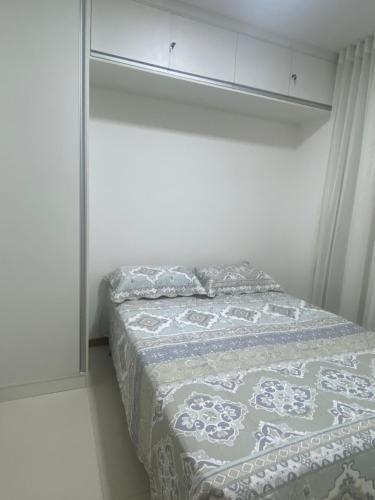 a bedroom with a bed with a blanket on it at Conforto e Paz in Imbassai