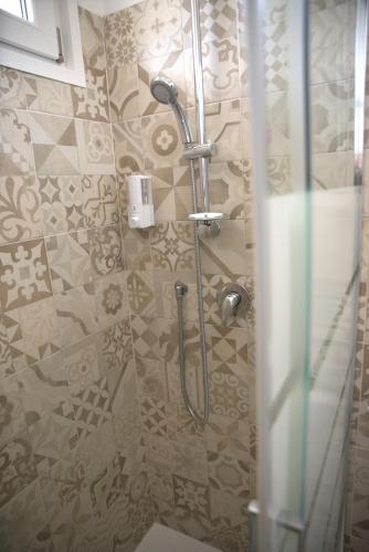 a shower in a bathroom with a glass door at b&b Casa Balai 72 a 100 mt dal mare in Porto Torres