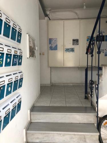 a room with a staircase in a room with machines at Ion Apartments Messolonghi Single Bed Room Mountain View Loft in Mesolongion