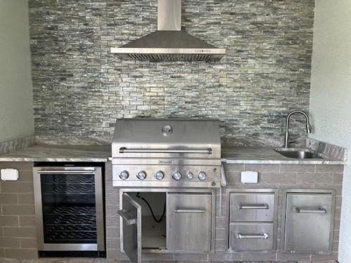a kitchen with a stainless steel stove and a sink at Memories on Madison by Sun Palace Vacations in Fort Myers Beach