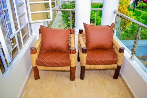 a pair of chairs sitting on a balcony at The Jades At Riat in Kisumu