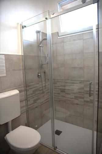 a bathroom with a glass shower with a toilet at b&b Casa Balai 72 a 100 mt dal mare in Porto Torres