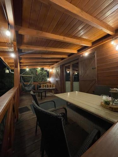 a patio with a table and chairs on a deck at Wilkaski zakątek in Giżycko