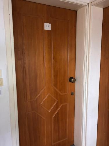 a wooden door with a sign on it in a room at Ion Apartments Messolonghi Double Room Sea View Loft in Mesolongion