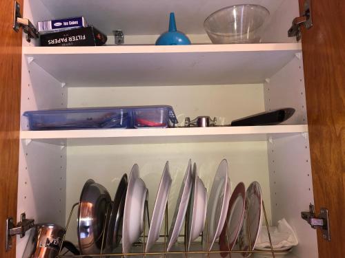 a shelf with a bunch of utensils on it at Ion Apartments Messolonghi Double Room Sea View Loft in Mesolongion