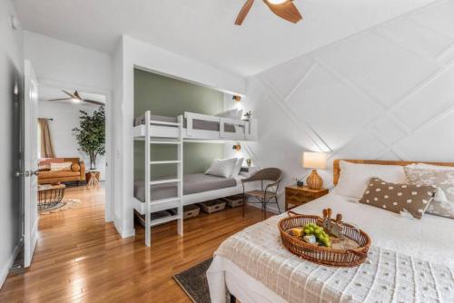 a bedroom with a bed with a basket of fruit on it at Bohemian Retreat in Traverse City