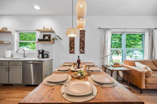 a kitchen and living room with a wooden table at Bohemian Retreat in Traverse City