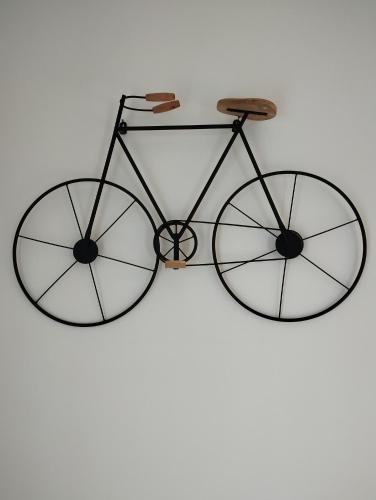 a bike with two wheels hanging on a wall at Casa Felix in Giulianova