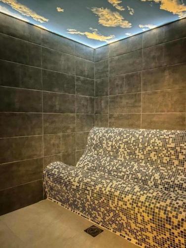 a couch sitting in a room with a wall at Dajoda Lux in Kopaonik