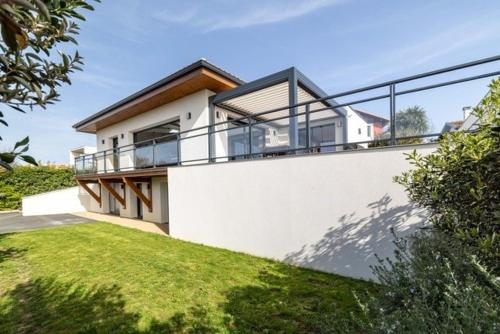 a house with a balcony on the side of it at Beautiful new ocean facing villa in Anglet