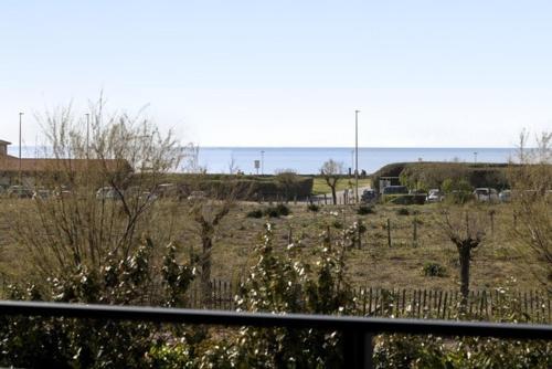 a view of a field with trees and a fence at Beautiful new ocean facing villa in Anglet