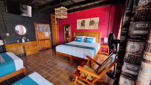 a bedroom with a large bed and red walls at Posada La Plazuela in Cuetzalán del Progreso