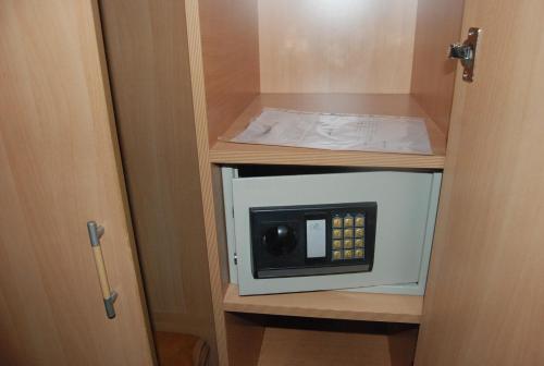 a microwave in a cabinet in a room at Hotel la princesse in Tunis