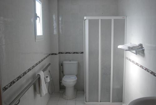 a bathroom with a toilet and a walk in shower at Hotel la princesse in Tunis
