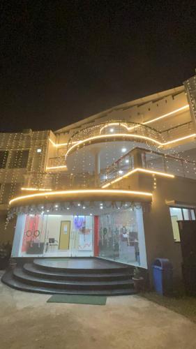 a building with lights on top of it at night at ICHHAMATI HOTEL AND RESTAURANT in Hāsnābād