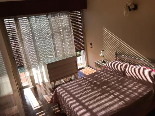 a bedroom with two beds and a large window at Large 2 floors in Carrasco in Montevideo