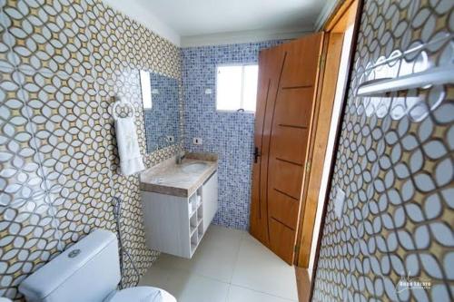 a bathroom with a toilet and a sink and a mirror at WS Beach Pousada in Porto De Galinhas