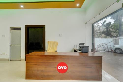 a wooden reception desk with a yes sign on it at Hotel O Dev Laxmi Palace Hotel & Banquet in Bihār Sharīf