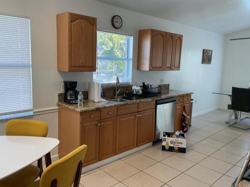 a kitchen with wooden cabinets and a counter top at Punta Gorda Home, Sleeps 10 in Punta Gorda