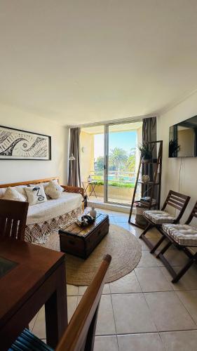a living room with a bed and a table at Costa del Este in Concón