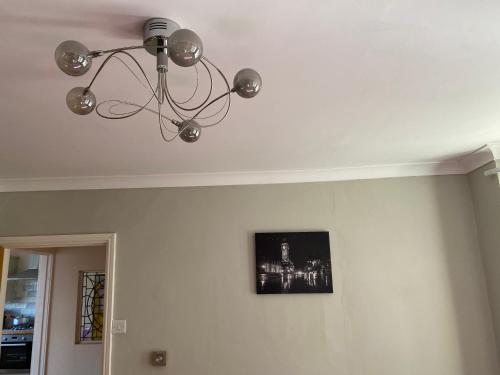 a chandelier hanging from a ceiling in a room at Private Lovely double bedroom in High Wycombe
