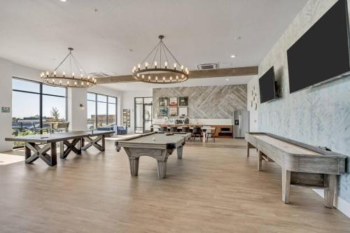 a large room with ping pong tables in it at Upscale 2BR w Pool Gym & Near Hill AFB in Clearfield