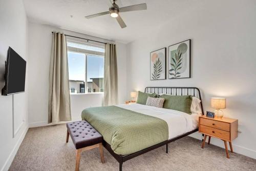 a bedroom with a bed and a flat screen tv at Upscale 2BR w Pool Gym & Near Hill AFB in Clearfield