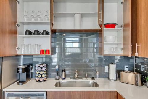 a kitchen with a sink and a counter top at Upscale 2BR w Pool Gym & Near Hill AFB in Clearfield