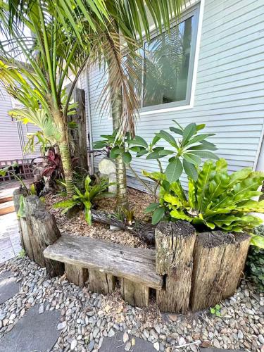 a garden with a wooden bench in front of a house at Newport Oases in Newport