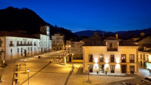 a city street at night with buildings and lights at Antiguo Casino Hotel in Pravia