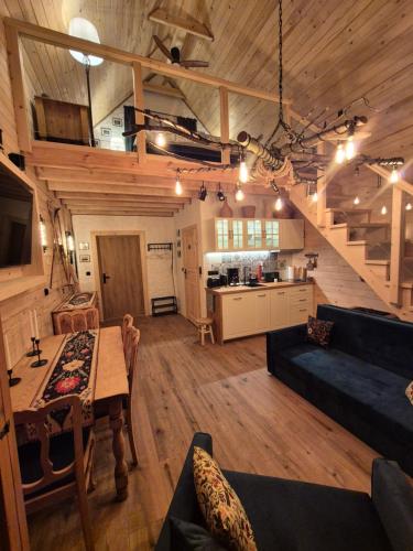 a large living room with a table and a kitchen at Woodland House 1 in Berezka