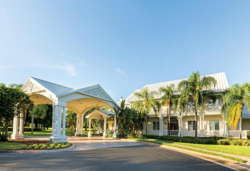 a large white house with palm trees at WorldMark Orlando Kingstown Reef in Orlando