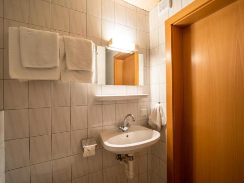 a bathroom with a sink and a mirror and towels at Apartment Marina in Vandans