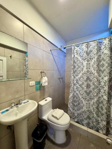 a bathroom with a toilet and a sink and a shower at TATA Hotel Boutique in Cusco