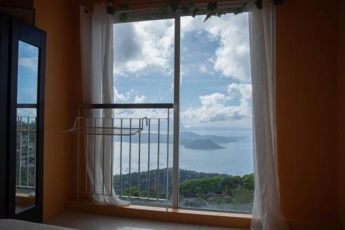 a large window with a view of the ocean at Wind Residences For Rent - Luiice in Tagaytay