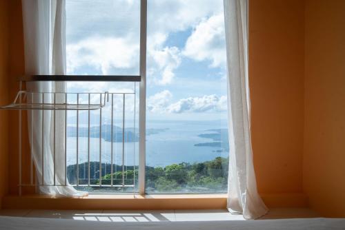 a window with a view of the ocean at Wind Residences For Rent - Luiice in Tagaytay