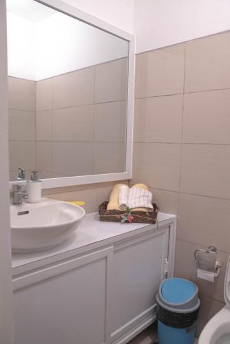 a bathroom with a sink and a mirror at Wind Residences For Rent - Luiice in Tagaytay