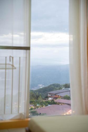 a window with a view of a city at Wind Residences For Rent - Luiice in Tagaytay