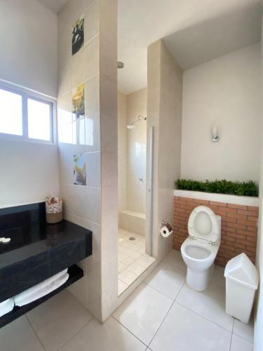 a bathroom with a toilet and a walk in shower at Melaque Paradise in San Patricio Melaque