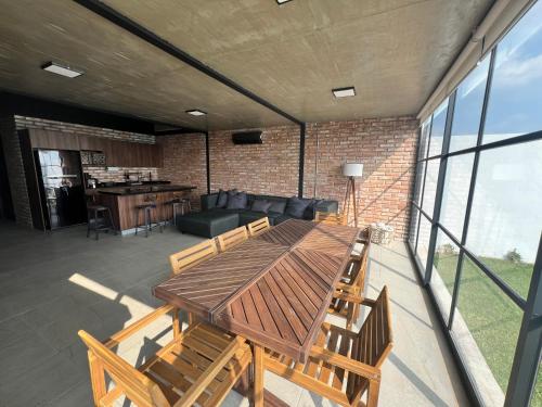 a patio with a wooden table and chairs at Casa con Alberca privada en Cuernavaca in Ahuatepec