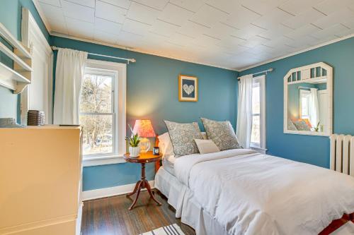 a blue bedroom with a bed and a table at Historic Poughkeepsie Home Near Arlington & Vassar in Poughkeepsie