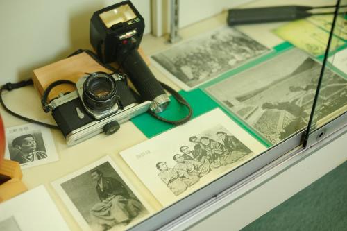 a camera sitting on a table with photos at Nisshokan Bettei Koyotei in Nagasaki