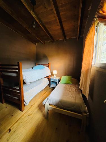 a bedroom with two twin beds and a window at Casa de Mar y Barro in Maldonado