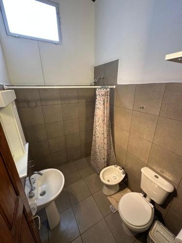 a bathroom with two toilets and a sink at EL PEDREGAL cabaña rural de 1 domitorio hasta 4 personas in Cafayate