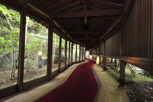a red carpet walkway in a building with windows at Nisshokan Bettei Koyotei in Nagasaki