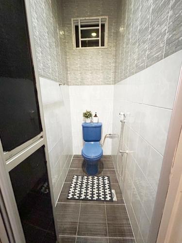 a bathroom with a blue toilet in a shower at BF Stay 2 in Kuala Terengganu