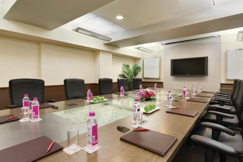 a conference room with a long table and chairs at Ramada by Wyndham Chennai Egmore in Chennai
