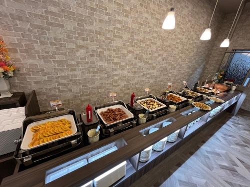 a buffet line with many different types of food at Hotel Route Inn Suzaka in Suzaka