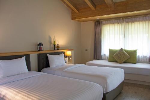 Ένα ή περισσότερα κρεβάτια σε δωμάτιο στο Mela Garden Retreat Cottage